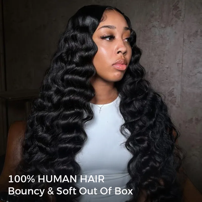 Woman with long, glossy black wavy hair wearing a white top, showcasing a hair product in a neutral setting (advertisement for 100% human hair)