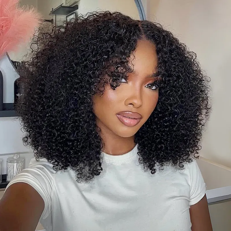 Portrait of a woman with voluminous curly black hair, wearing a white shirt, and glossy makeup, taking a selfie in a bright room