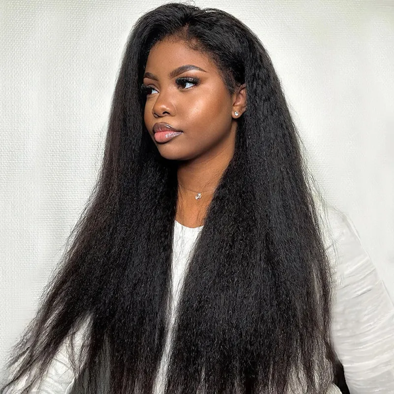 Portrait of a woman with long, straight black hair wearing a white top against a light background.